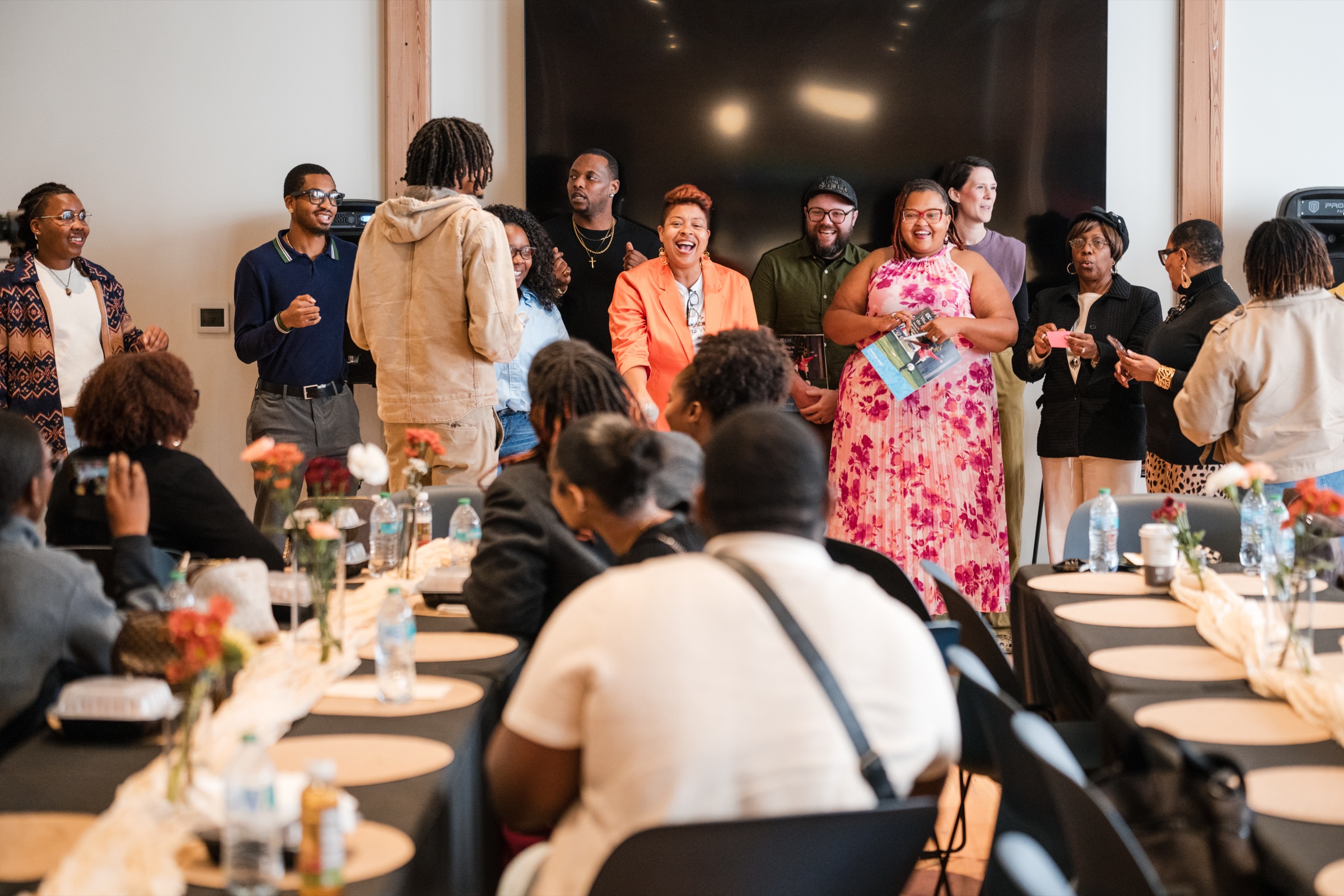 Kinnctd community gathering — speakers and members at an in-person event